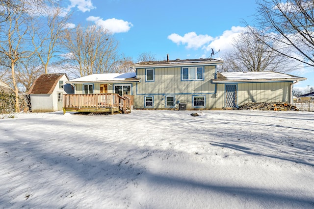 snow covered property with a wooden deck