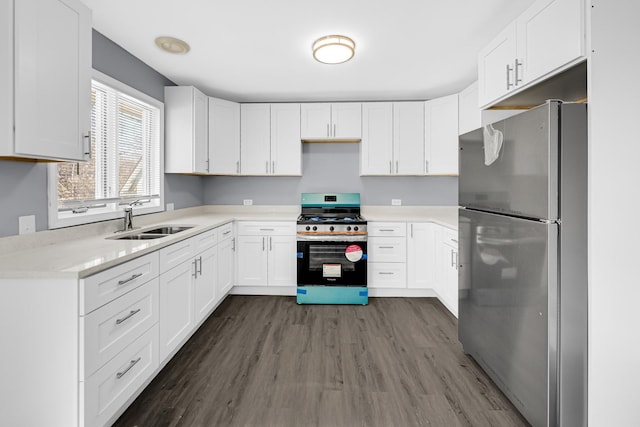 kitchen featuring sink, stainless steel appliances, white cabinets, and dark hardwood / wood-style floors