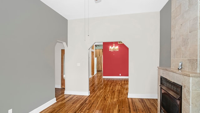 unfurnished living room with a fireplace and wood-type flooring