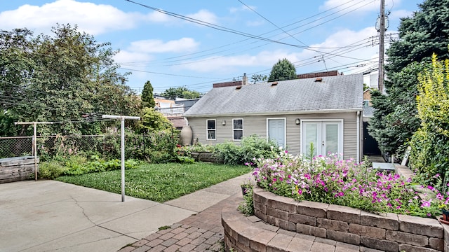 back of house featuring a patio area and a lawn