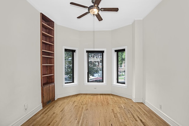 unfurnished room with light hardwood / wood-style flooring, ornamental molding, and ceiling fan