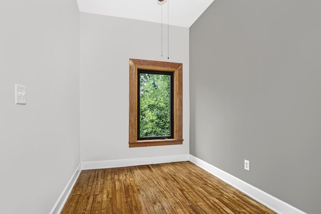 unfurnished room with hardwood / wood-style floors