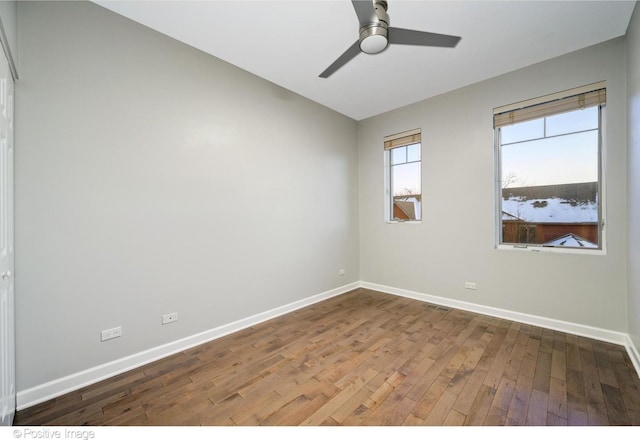 empty room featuring ceiling fan and hardwood / wood-style flooring