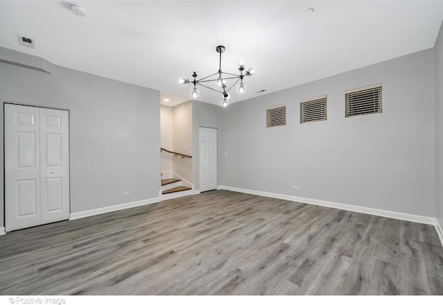 empty room featuring light hardwood / wood-style floors and an inviting chandelier