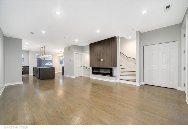 unfurnished living room with a fireplace and wood-type flooring