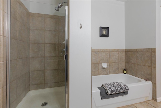 bathroom featuring plus walk in shower and tile patterned floors