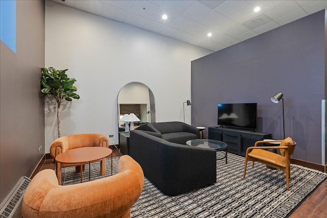 living room with a drop ceiling and dark hardwood / wood-style floors