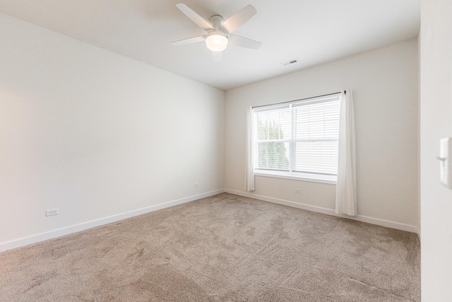 carpeted empty room featuring ceiling fan