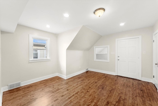 bonus room with lofted ceiling and hardwood / wood-style flooring