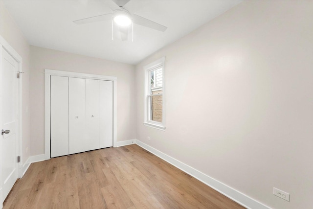 unfurnished bedroom featuring ceiling fan, light hardwood / wood-style floors, and a closet