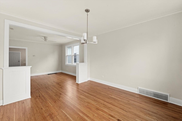 interior space with ornamental molding, hardwood / wood-style floors, and ceiling fan with notable chandelier