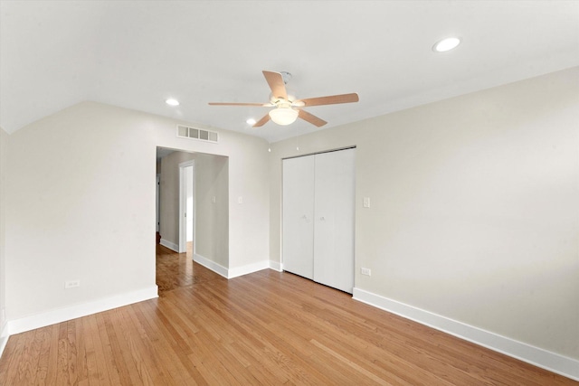 unfurnished bedroom featuring a closet, ceiling fan, and light wood-type flooring