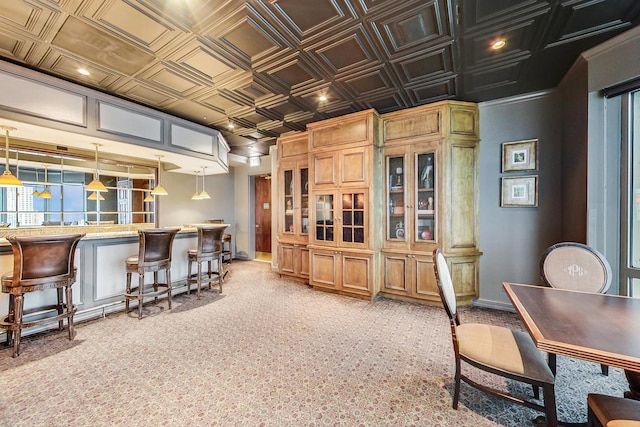 kitchen featuring pendant lighting and light colored carpet