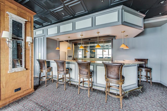 bar featuring hanging light fixtures, crown molding, and dark colored carpet