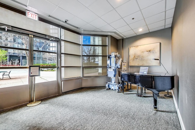 miscellaneous room featuring a paneled ceiling and carpet flooring