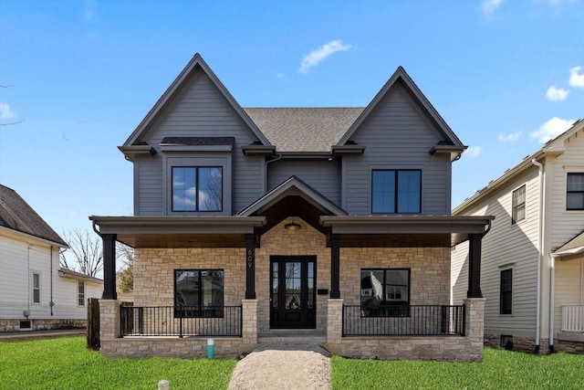 craftsman inspired home with a front yard and a porch