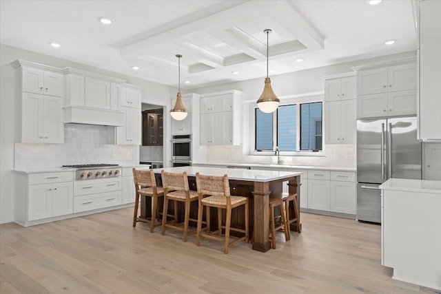 kitchen featuring white cabinets, pendant lighting, and a kitchen island