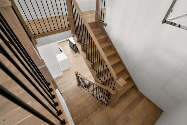 stairway with hardwood / wood-style flooring