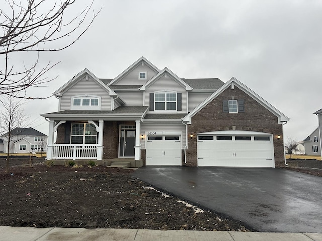 view of front of property featuring a garage and a porch