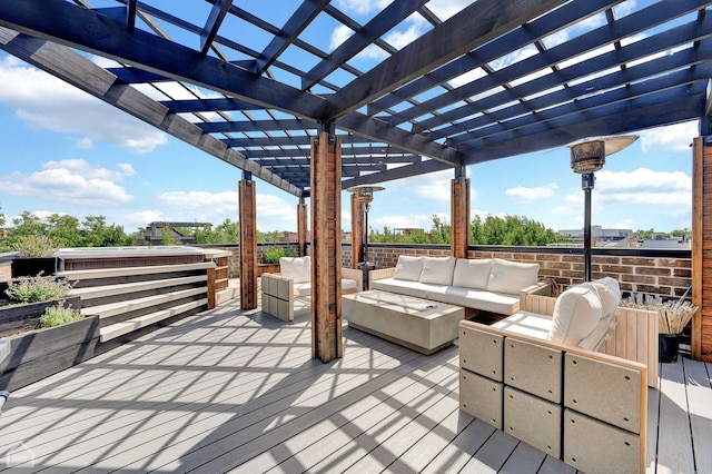 wooden deck with an outdoor hangout area and a pergola