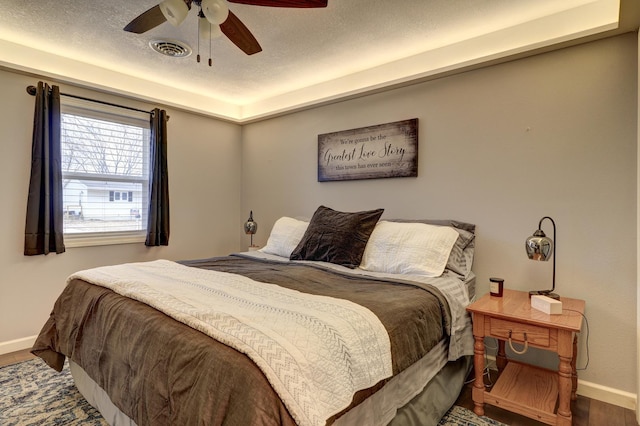 bedroom with ceiling fan and wood-type flooring