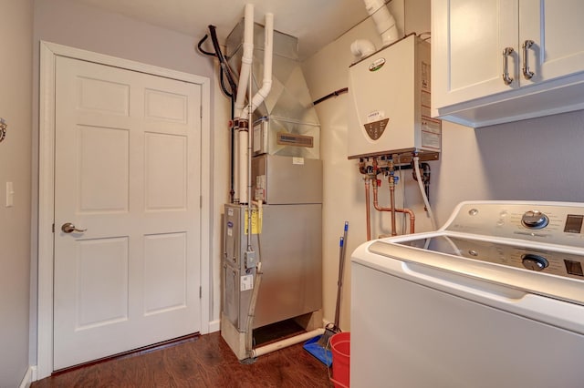 laundry room featuring washer / dryer, tankless water heater, dark wood-type flooring, cabinets, and heating unit