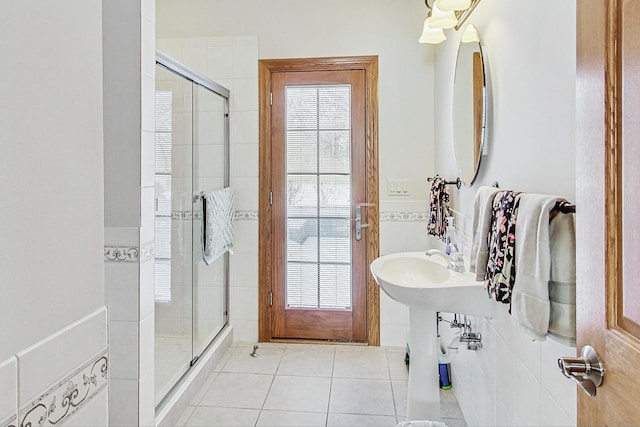 bathroom featuring a shower with door and tile patterned floors