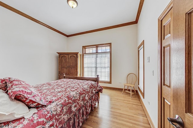 bedroom with crown molding and light hardwood / wood-style flooring