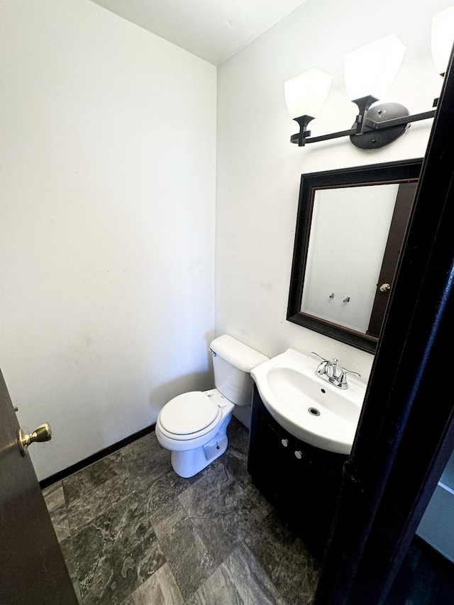 bathroom with toilet and vanity