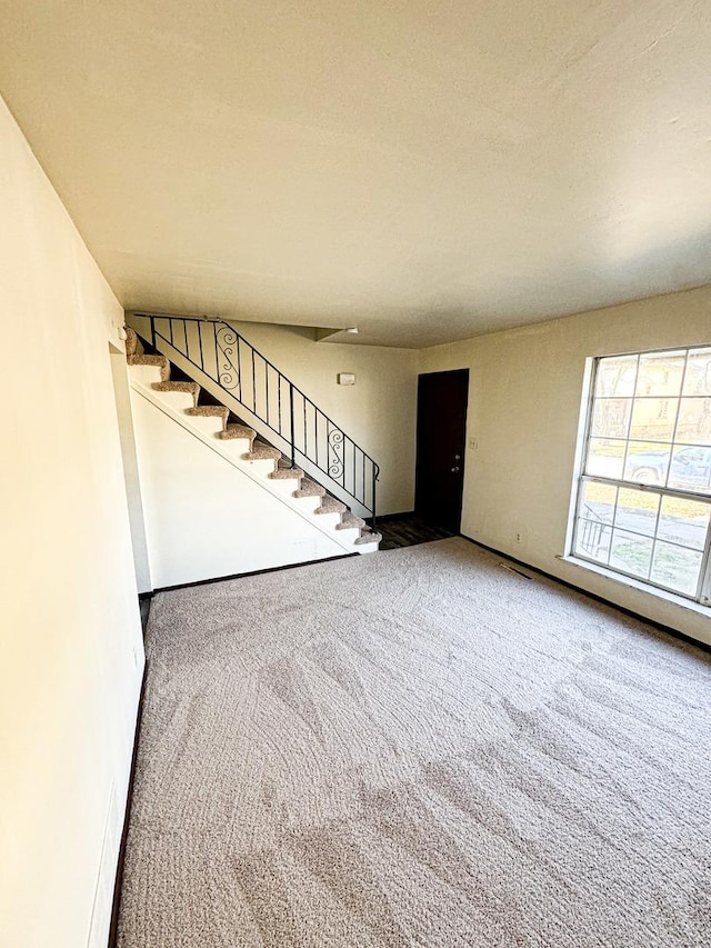 unfurnished living room with carpet