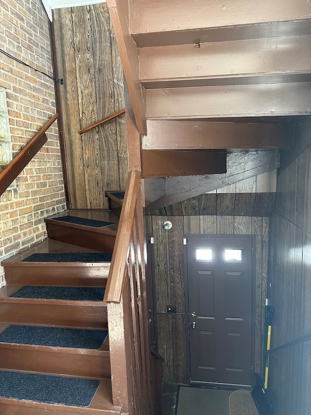 stairway with wood walls and brick wall