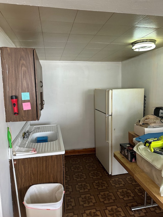 kitchen with sink and white fridge