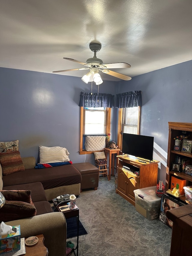 carpeted living room with ceiling fan