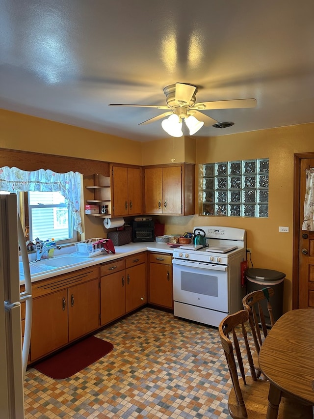 kitchen featuring sink, ceiling fan, refrigerator, and white stove