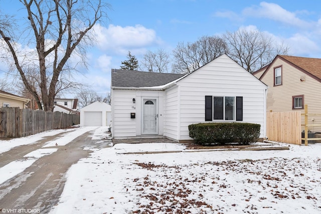 bungalow-style house featuring an outdoor structure and a garage