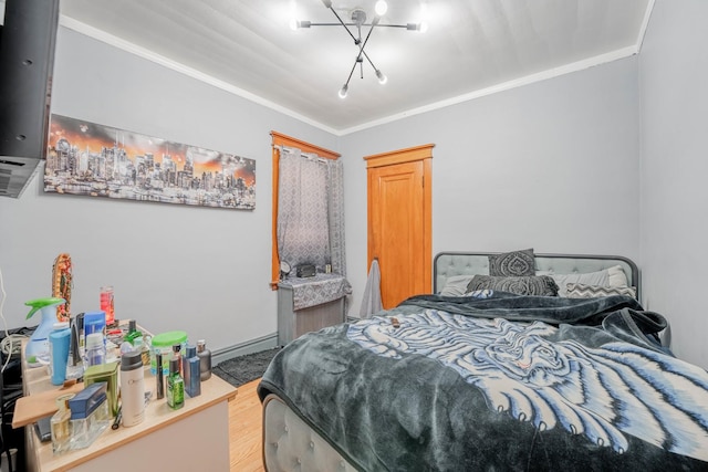 bedroom with wood-type flooring, an inviting chandelier, and ornamental molding