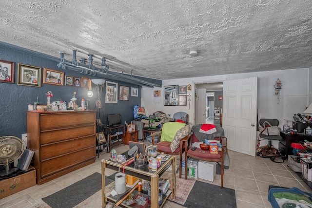 interior space with a textured ceiling and light tile patterned floors