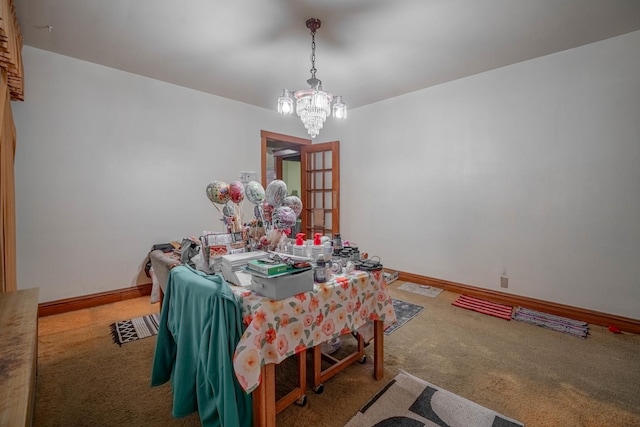 dining room featuring an inviting chandelier and carpet flooring