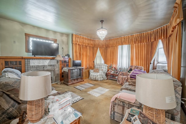 carpeted living room with a chandelier