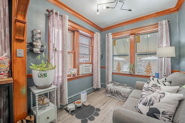 living area with a healthy amount of sunlight, cooling unit, ornamental molding, and light hardwood / wood-style floors