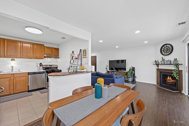 kitchen featuring decorative backsplash, appliances with stainless steel finishes, and sink