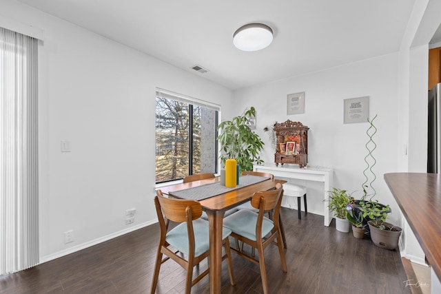 dining area featuring dark hardwood / wood-style flooring