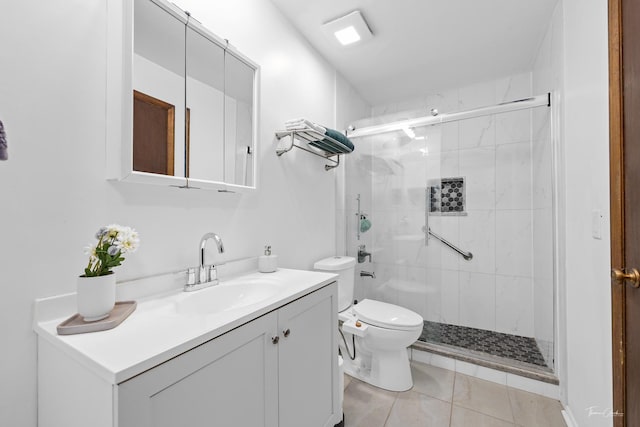 bathroom with an enclosed shower, vanity, toilet, and tile patterned flooring