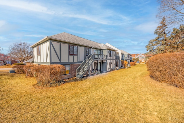 back of house with a deck and a yard