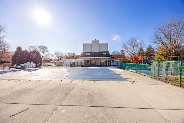 view of swimming pool featuring a playground