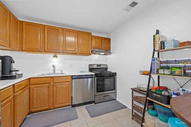 kitchen with decorative backsplash, sink, appliances with stainless steel finishes, and light tile patterned flooring