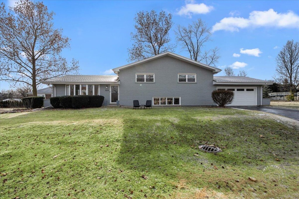 view of front of house with a front yard and a garage