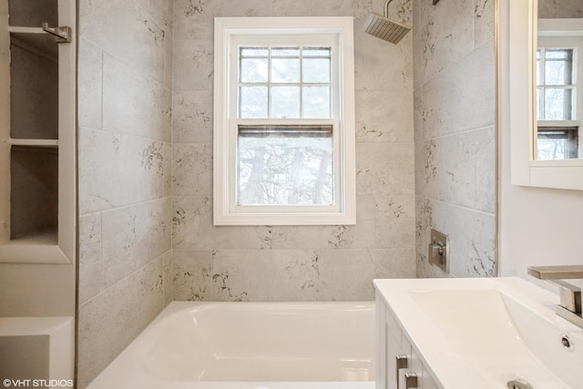 bathroom featuring tiled shower / bath combo and vanity