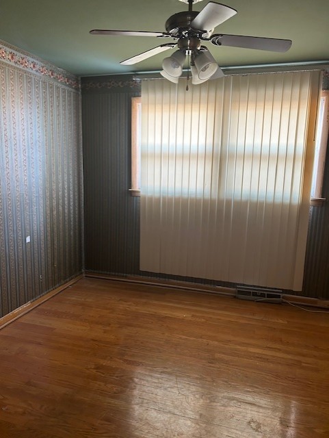 spare room featuring ceiling fan and hardwood / wood-style floors