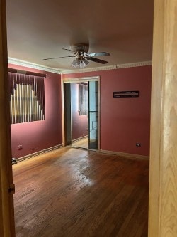 spare room with ceiling fan, crown molding, and hardwood / wood-style floors